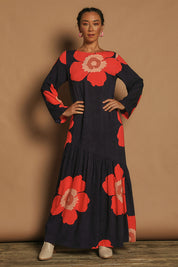 Model Katie wearing size 10 of the Ola Asymmetric Seam Dress in colour Boldflower (Blue), from the front, showing the whole outfit