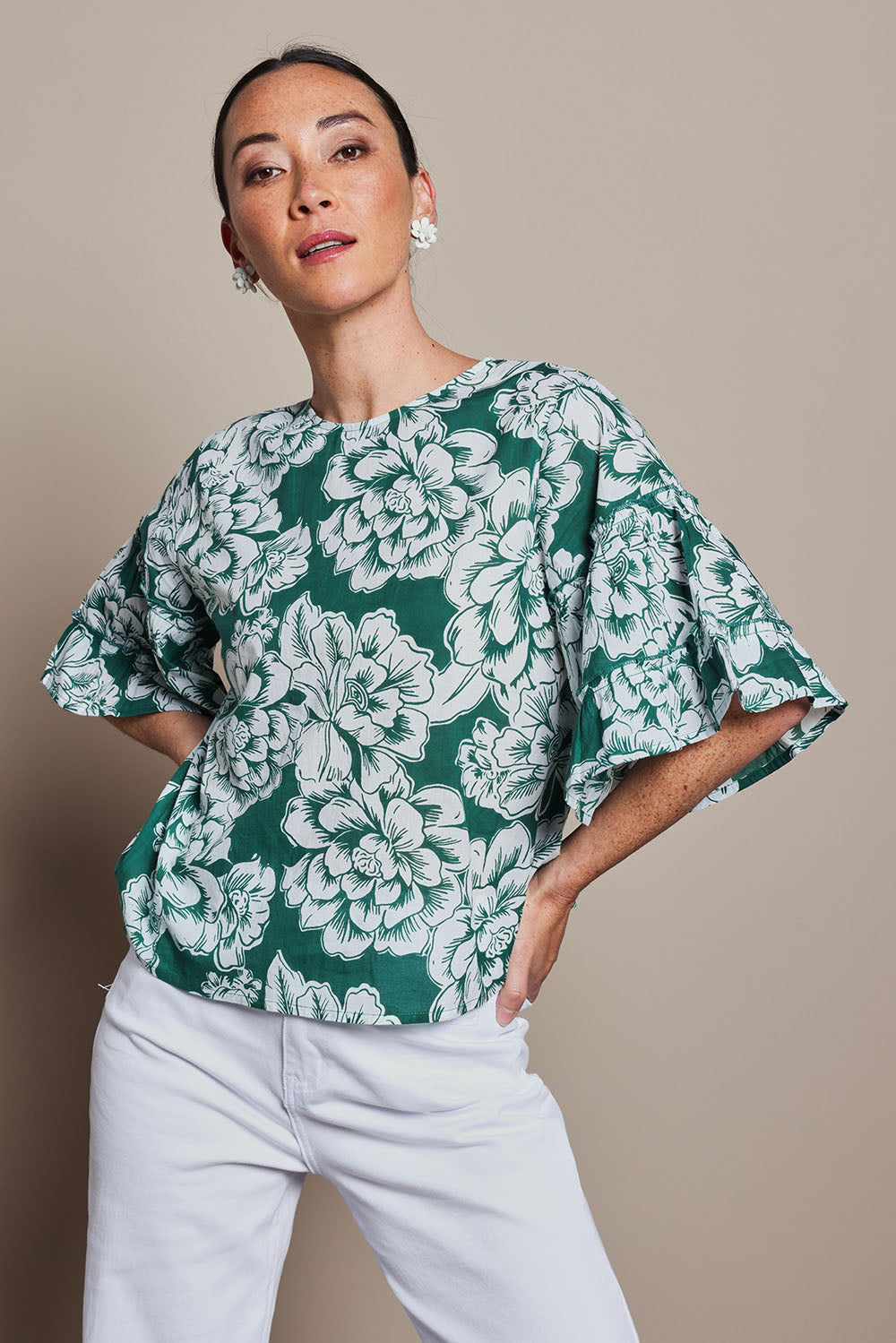 Model Tahnee wearing size 10 of the Kylie Frill Sleeve Cotton Top in colour Blooming (Green), from the front, cropped image