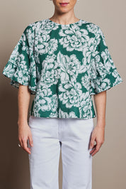 Model Tahnee wearing size 10 of the Kylie Frill Sleeve Cotton Top in colour Blooming (Green), from the front, cropped image