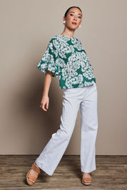 Model Tahnee wearing size 10 of the Kylie Frill Sleeve Cotton Top in colour Blooming (Green), from the front, showing the whole outfit