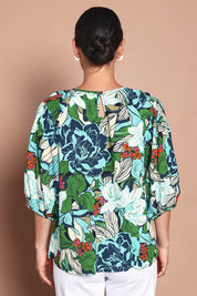 Model Katie wearing size 10 of the Ria Puff Sleeve Top in colour Bouquet, from the back