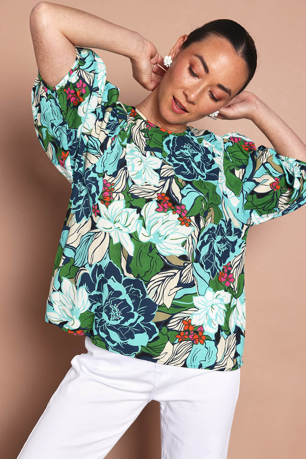 Model Katie wearing size 10 of the Ria Puff Sleeve Top in colour Bouquet, from the front, cropped image