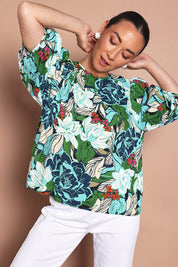 Model Katie wearing size 10 of the Ria Puff Sleeve Top in colour Bouquet, from the front, cropped image
