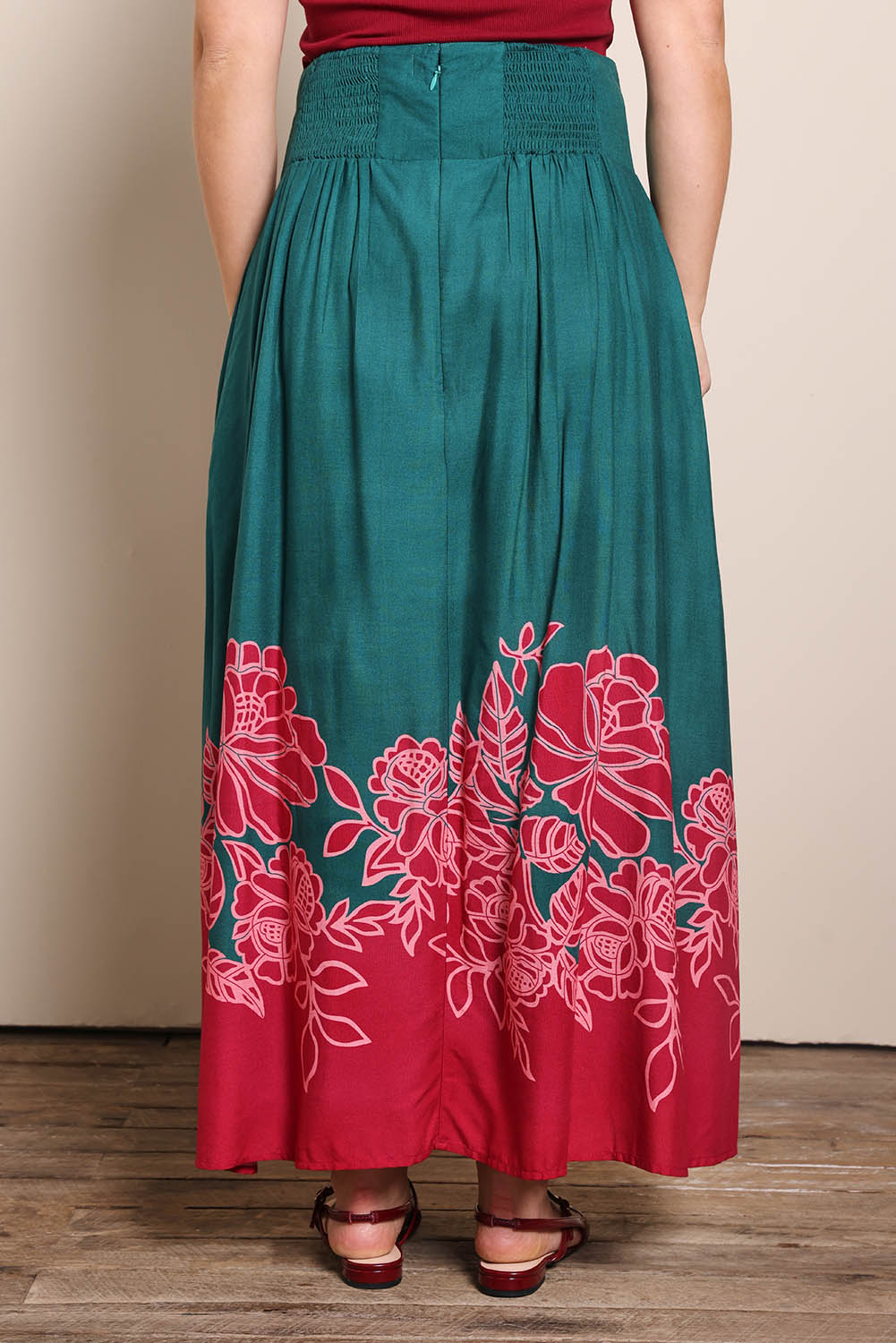 Model Georgiel wearing size 10 of the Rosemary Maxi Skirt – Rosepetal in colour Rosepetal, from the back