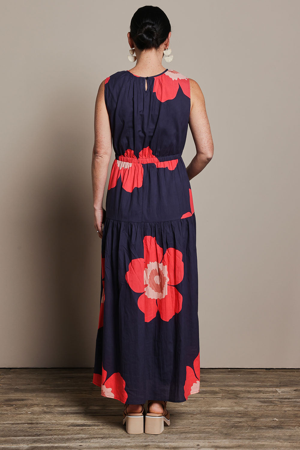 Model Katie wearing size 10 of the Riley Cotton Maxi Dress in colour Boldflower (Blue), from the back