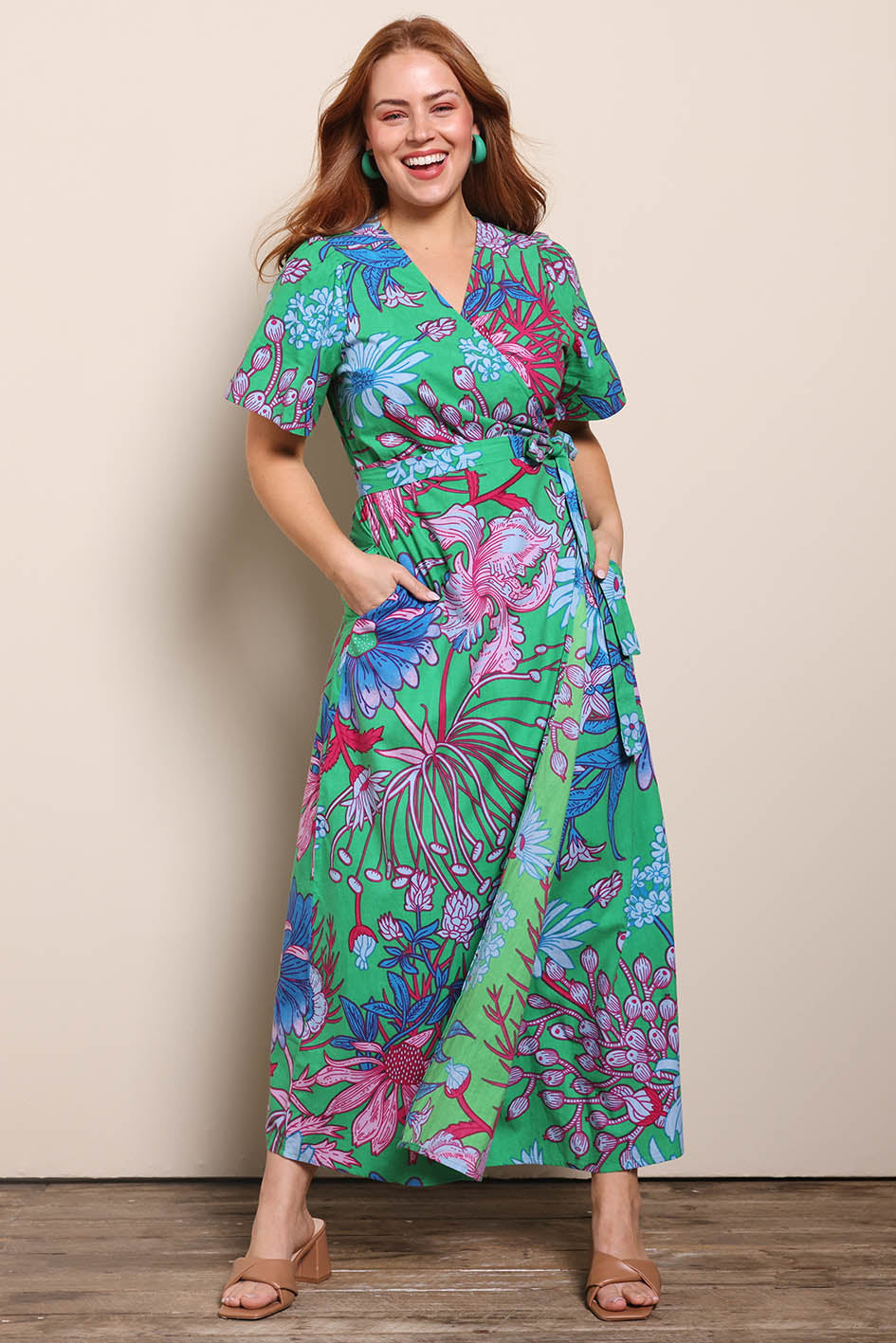 Model Georgiel wearing size 10 of the Lilly Cotton Wrap Dress – Greengard in colour Greengard, from the front
