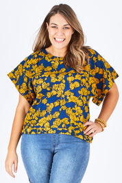 Model Natalia wearing size 14 of the Lola Bell Sleeve Top Entangled Vines in colour Gold, from the front, cropped image