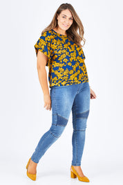 Model Natalia wearing size 14 of the Lola Bell Sleeve Top Entangled Vines in colour Gold, from the front, showing the whole outfit