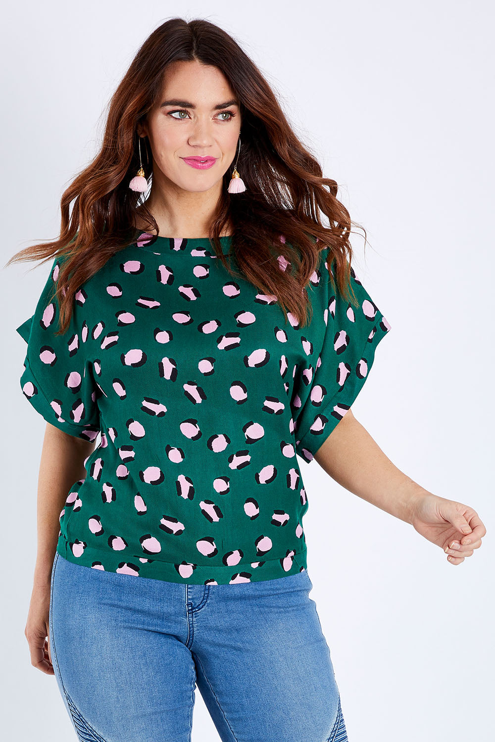 Model Laura wearing size 14 of the Lola Belle Sleeve Top in colour Leopard (Green), from the front, cropped image