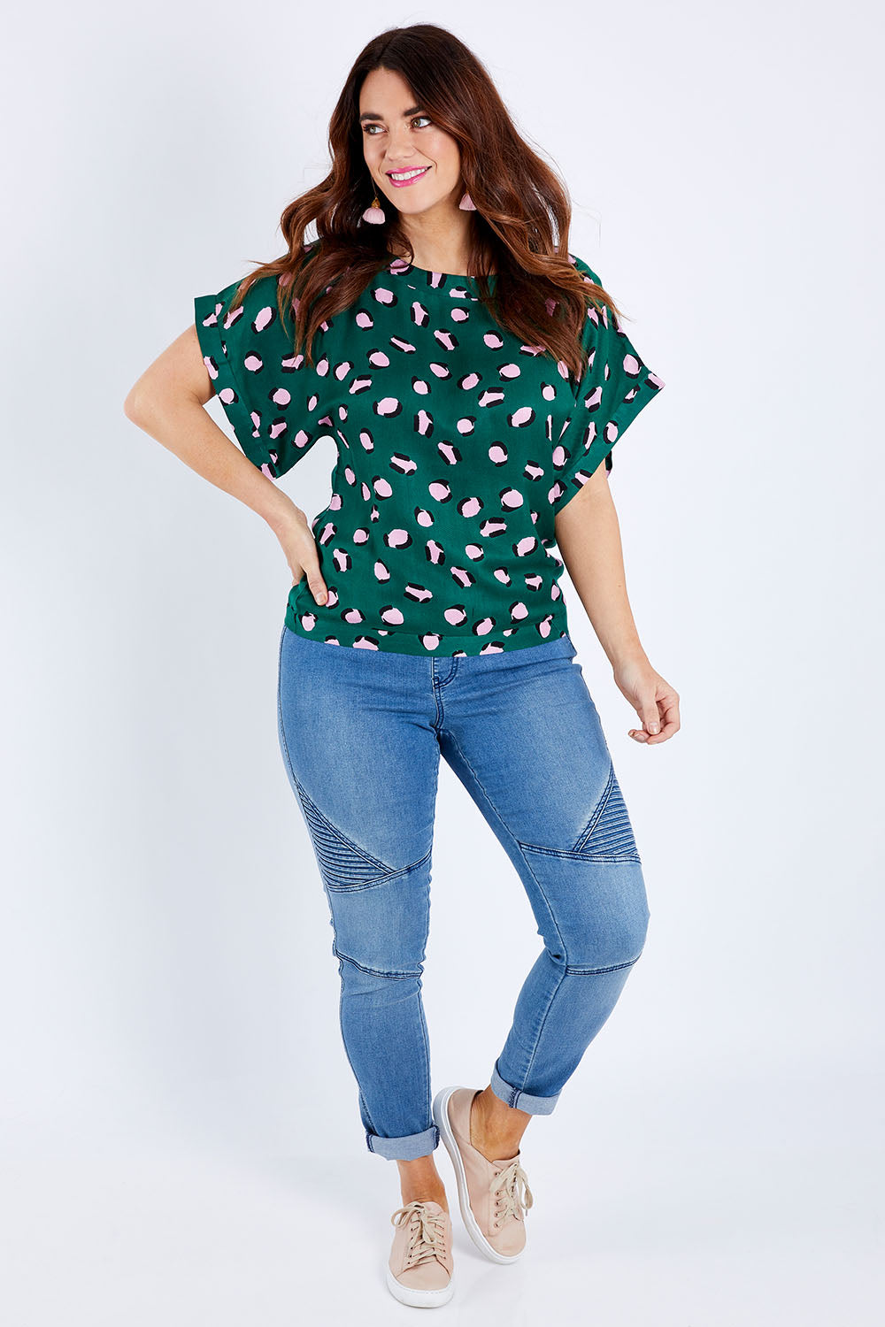 Model Laura wearing size 14 of the Lola Belle Sleeve Top in colour Leopard (Green), from the front, showing the whole outfit