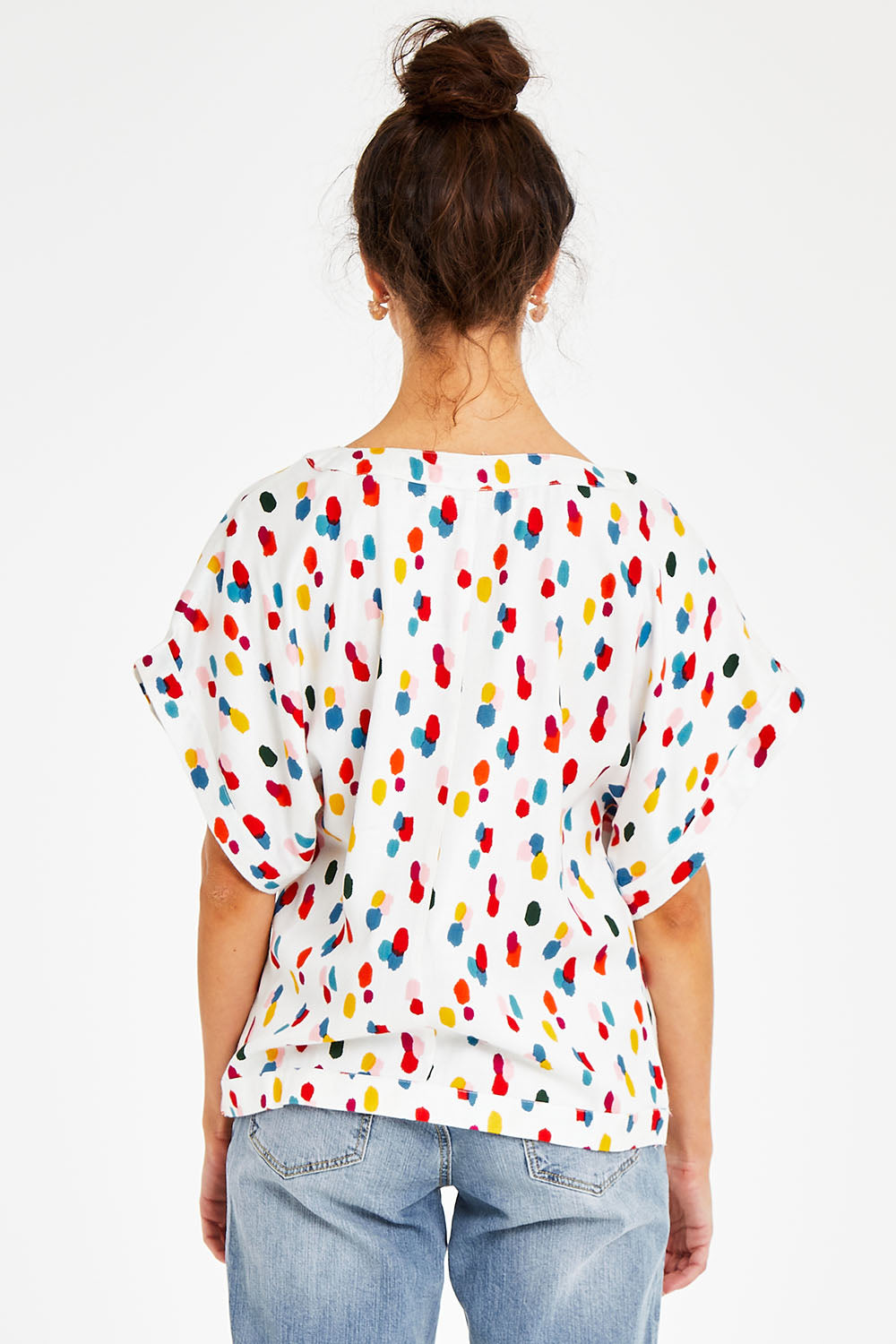 Model Courtney wearing size 10 of the Lola Belle Sleeve Top in colour Speckled (White), from the back