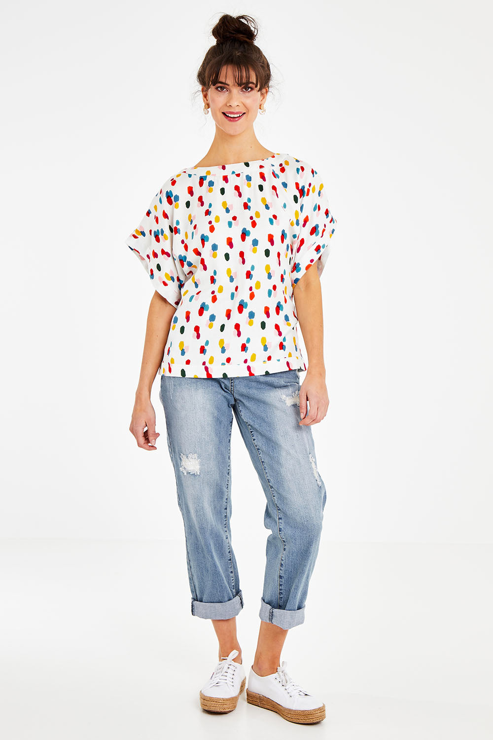 Model Courtney wearing size 10 of the Lola Belle Sleeve Top in colour Speckled (White), from the front, showing the whole outfit