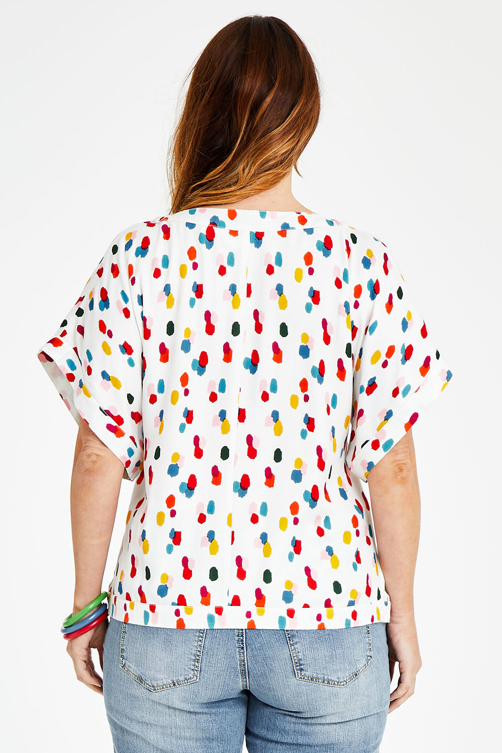 Model Laura wearing size 14 of the Lola Belle Sleeve Top in colour Speckled (White), from the back