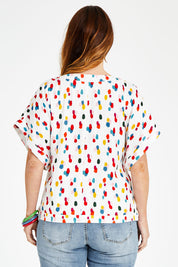 Model Laura wearing size 14 of the Lola Belle Sleeve Top in colour Speckled (White), from the back