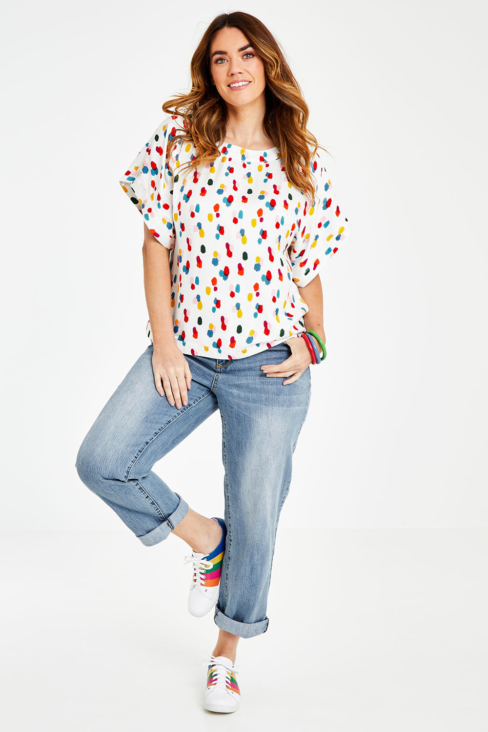 Model Laura wearing size 14 of the Lola Belle Sleeve Top in colour Speckled (White), from the front, showing the whole outfit