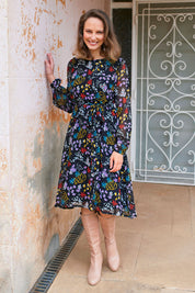 Model Alex wearing size 10 of the Odette Dress Garden Dweller in colour Black (Black), from the front, showing the whole outfit