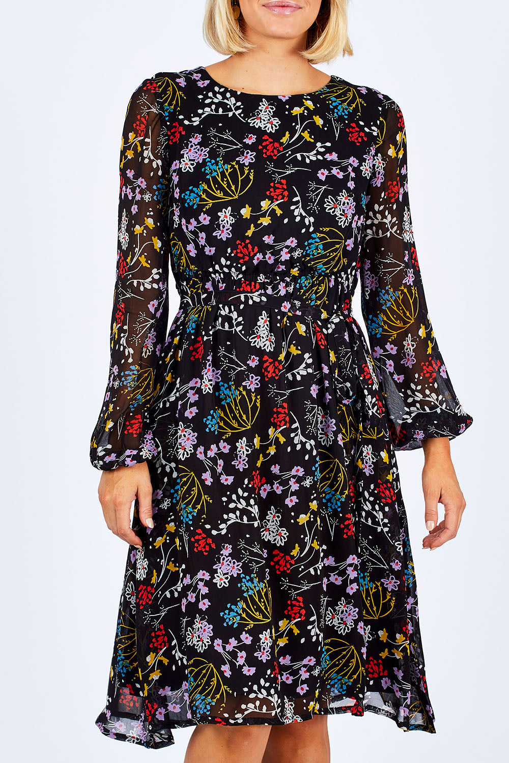 Model Emma wearing size 10 of the Odette Dress Garden Dweller in colour Black (Black), from the front, cropped image