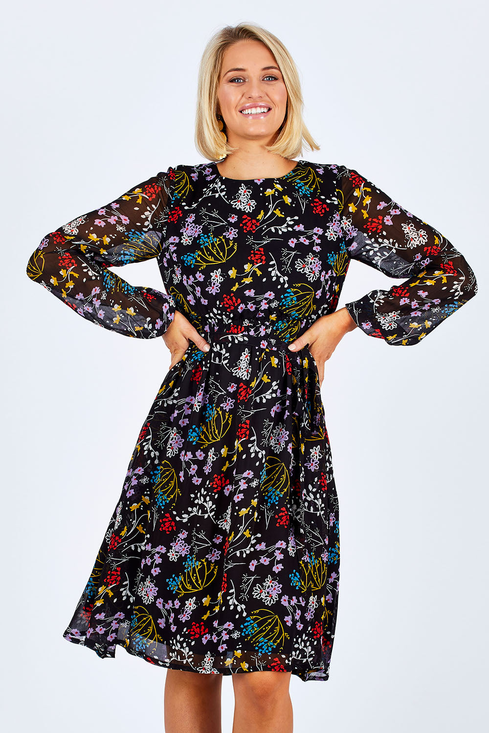 Model Emma wearing size 10 of the Odette Dress Garden Dweller in colour Black (Black), from the front, cropped image