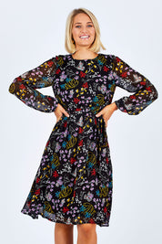 Model Emma wearing size 10 of the Odette Dress Garden Dweller in colour Black (Black), from the front, cropped image