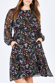 Model Sophie wearing size 14 of the Odette Dress Garden Dweller in colour Black (Black), from the front, cropped image