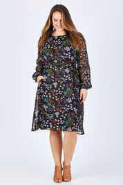 Model Sophie wearing size 14 of the Odette Dress Garden Dweller in colour Black (Black), from the front, showing the whole outfit