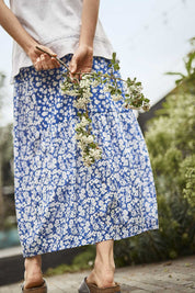 A model wearing the Verronica Organic Cotton Skirt in colour Marine (Blue), from the front, showing the whole outfit