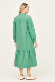 A model wearing the Winnie Shirt Dress in colour Foamgreen (Green), from the back