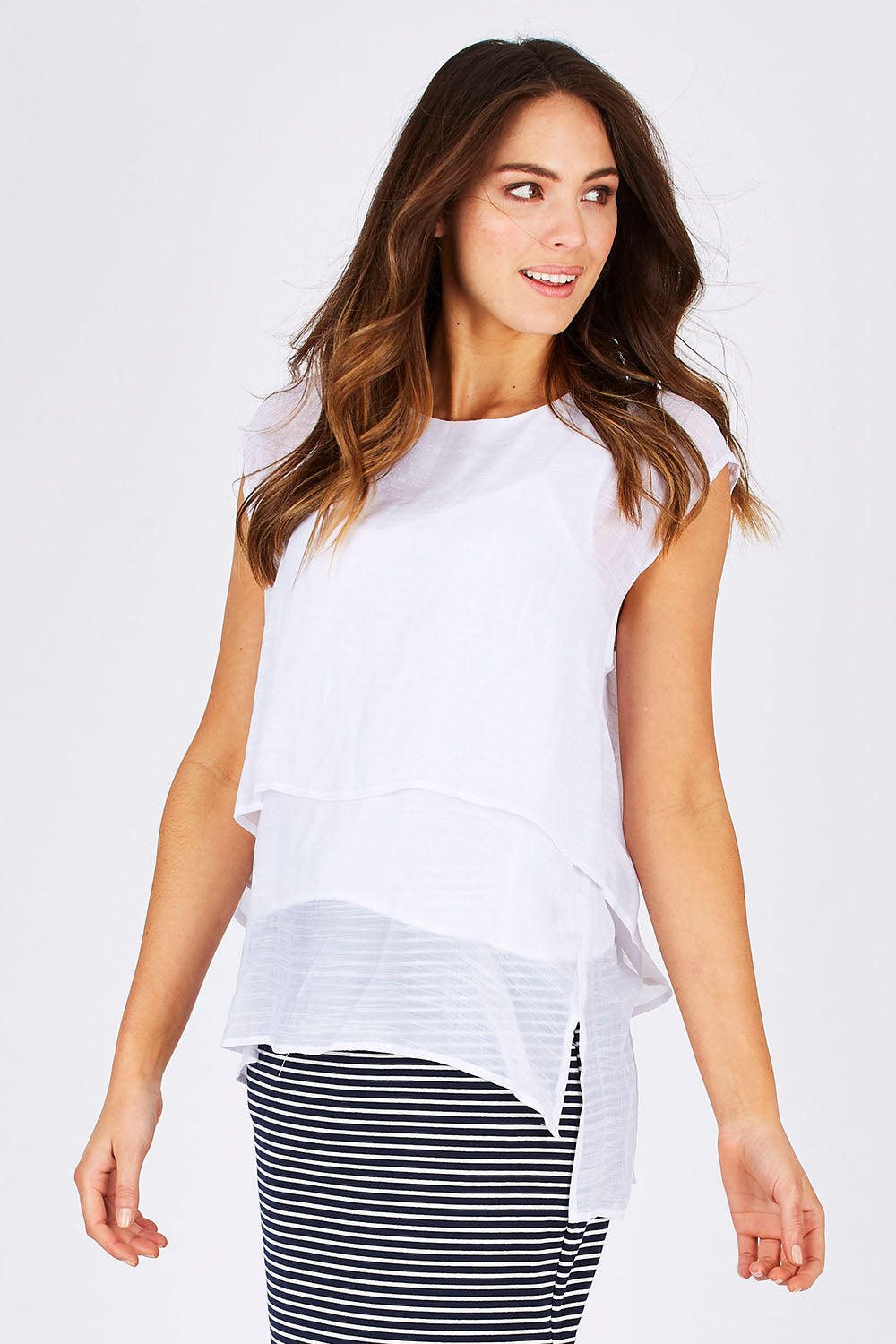 Model Madeline wearing size S of the Layered Top in colour White (White), from the front, cropped image