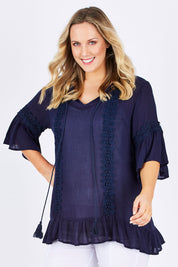 Model Jess wearing size L of the Lace Trim Kaftan in colour Navy (Blue), from the front, cropped image