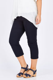 Model Jess wearing size L of the Eyelet Trim Pant in colour Navy (Blue), from the front, cropped image