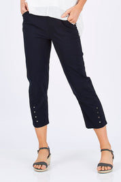 Model Monique wearing size S of the Eyelet Trim Pant in colour Navy (Blue), from the front, cropped image