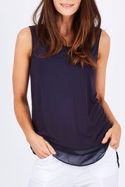 Model Monique wearing size S of the Reversible Scoop/v Neck Tank in colour Navy (Blue), from the front, cropped image