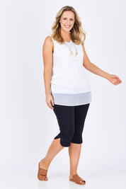 Model Jess wearing size L of the Reversible Scoop/v Neck Tank in colour White (White), from the front, showing the whole outfit