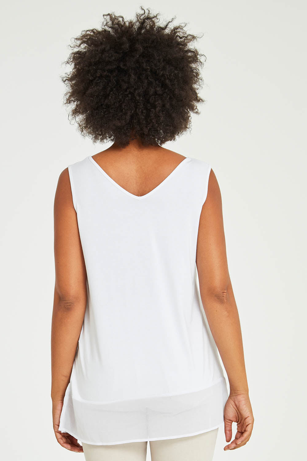 Model Olivia wearing size S of the Reversible Scoop/v Neck Tank in colour White (White), from the back