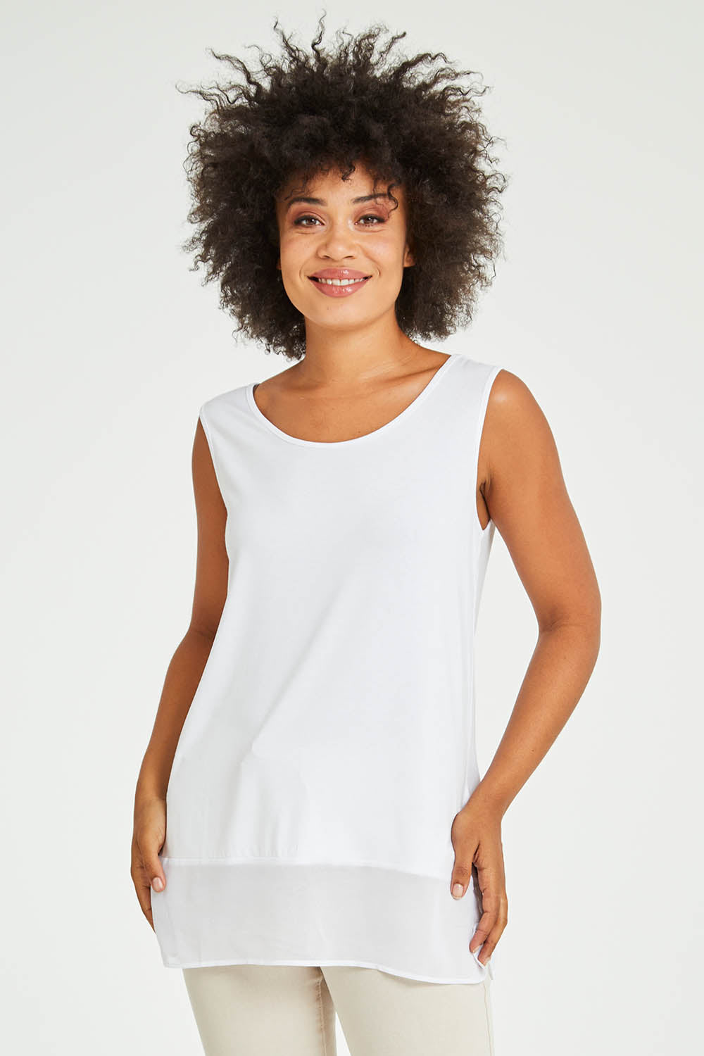 Model Olivia wearing size S of the Reversible Scoop/v Neck Tank in colour White (White), from the front, cropped image