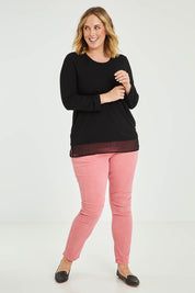 Model Jess wearing size L of the L/S Georgette Hem Top in colour Black (Black), from the front, showing the whole outfit