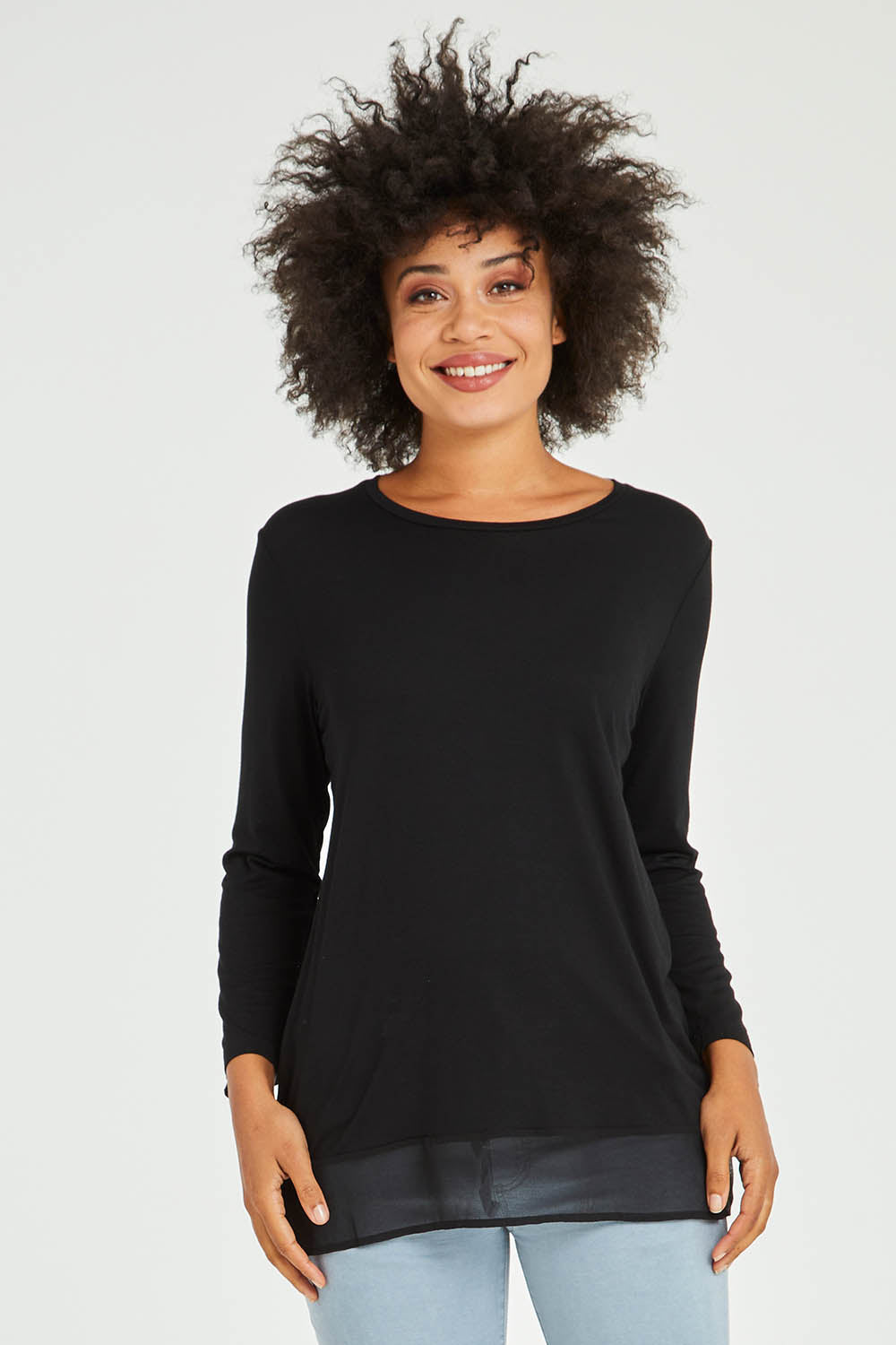 Model Olivia wearing size S of the L/S Georgette Hem Top in colour Black (Black), from the front, cropped image