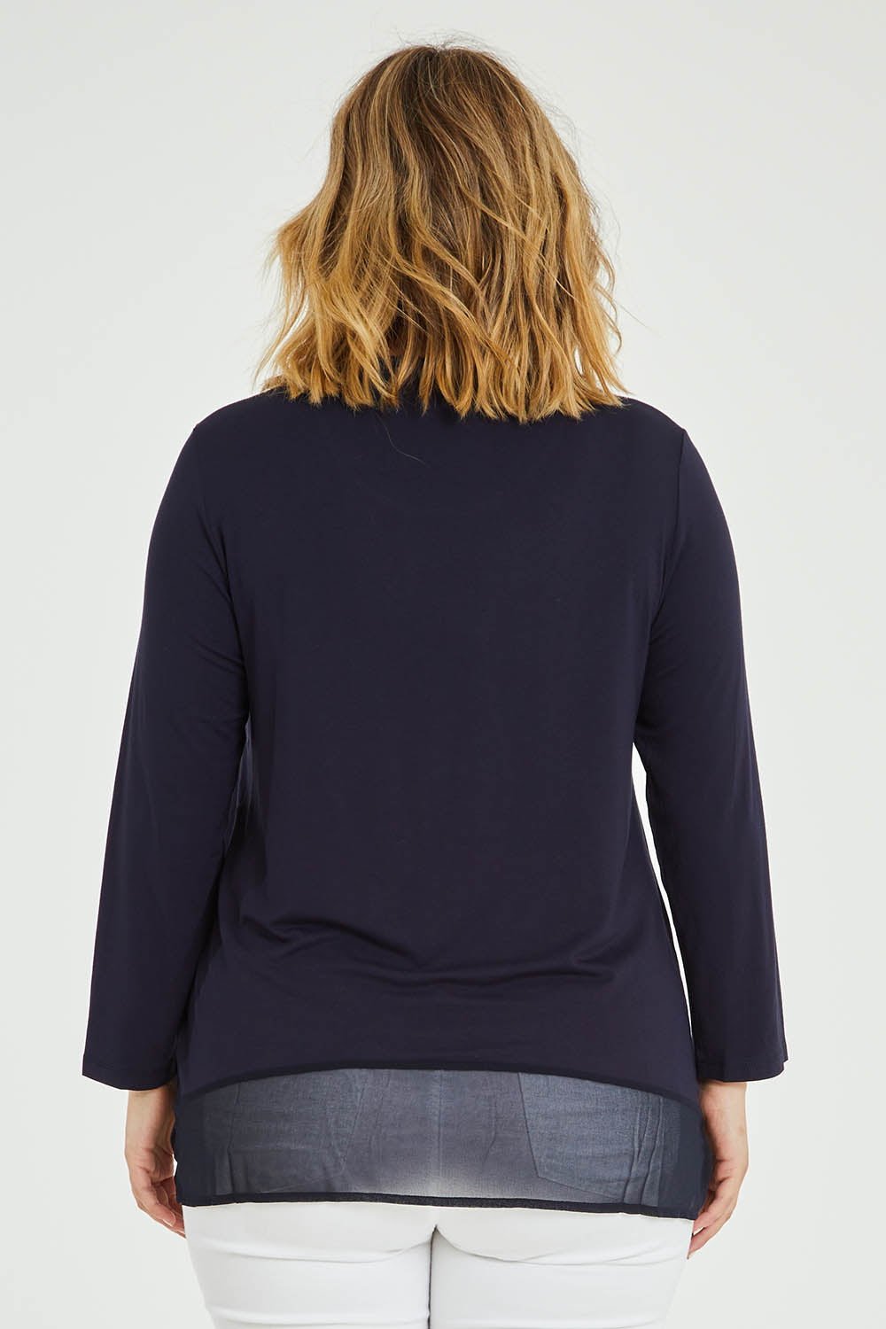 Model Jess wearing size L of the L/S Georgette Hem Top in colour Navy (Blue), from the back