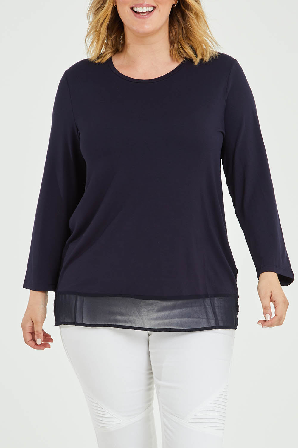 Model Jess wearing size L of the L/S Georgette Hem Top in colour Navy (Blue), from the front, cropped image