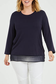 Model Jess wearing size L of the L/S Georgette Hem Top in colour Navy (Blue), from the front, cropped image