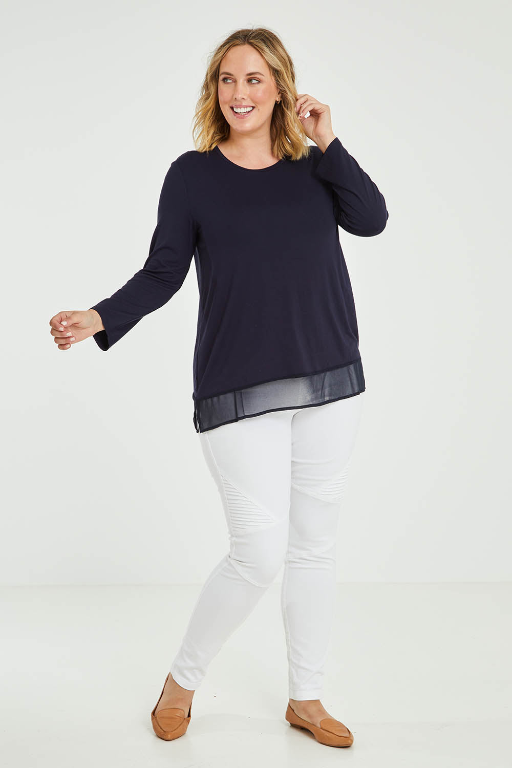 Model Jess wearing size L of the L/S Georgette Hem Top in colour Navy (Blue), from the front, showing the whole outfit