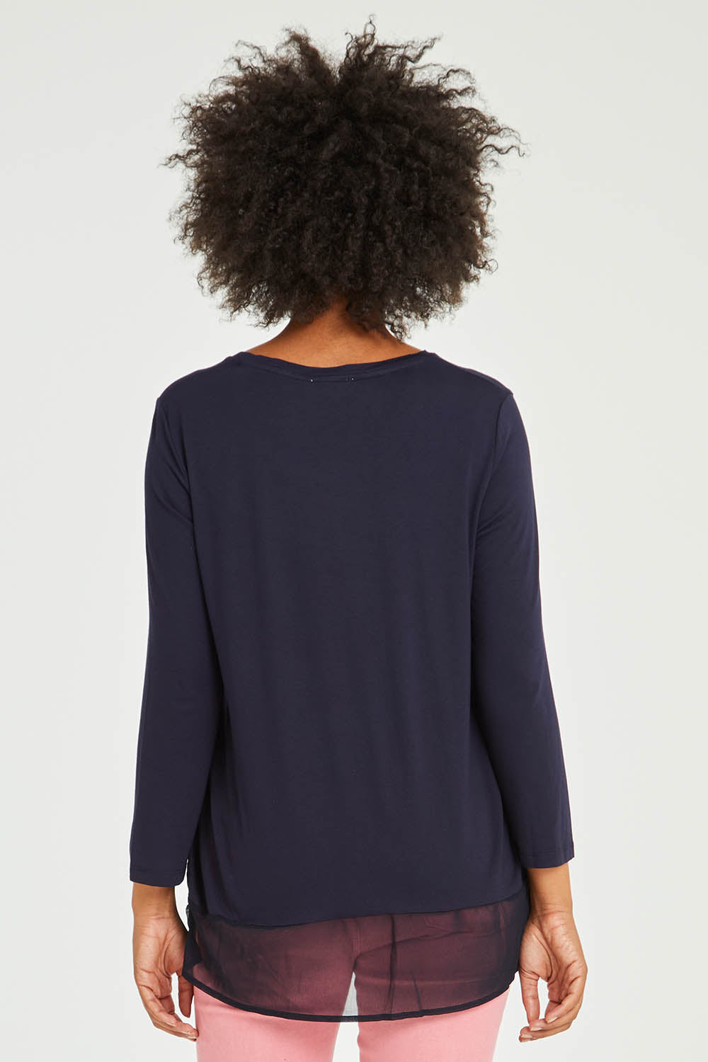 Model Olivia wearing size S of the L/S Georgette Hem Top in colour Navy (Blue), from the back