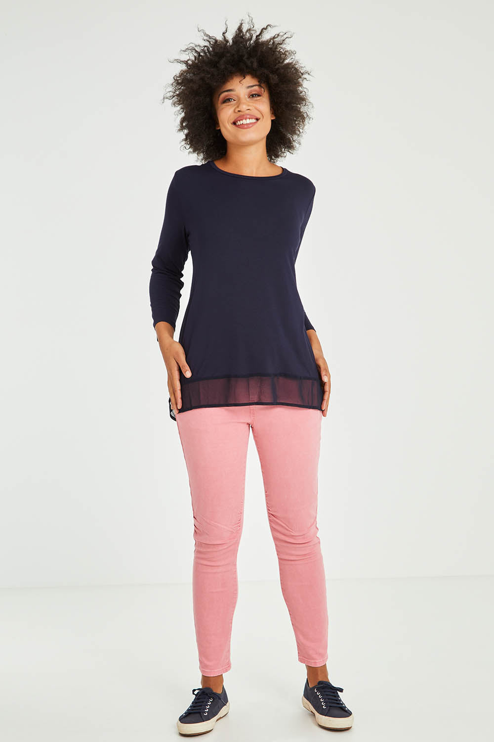 Model Olivia wearing size S of the L/S Georgette Hem Top in colour Navy (Blue), from the front, showing the whole outfit