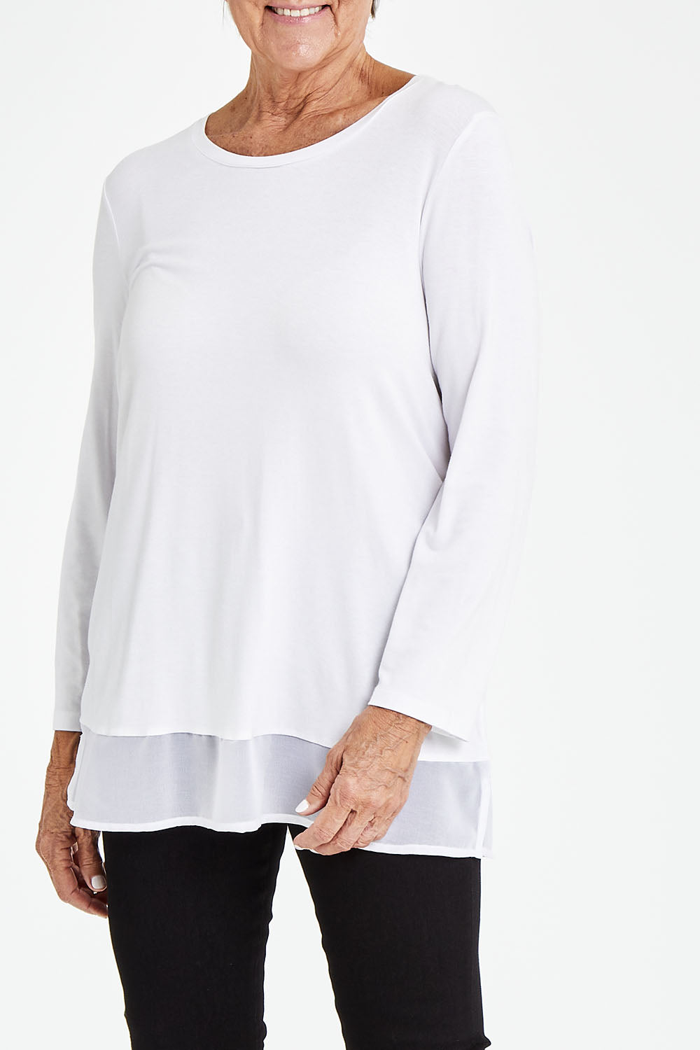 Model Elise wearing size S of the L/S Georgette Hem Top in colour White (White), from the front, cropped image