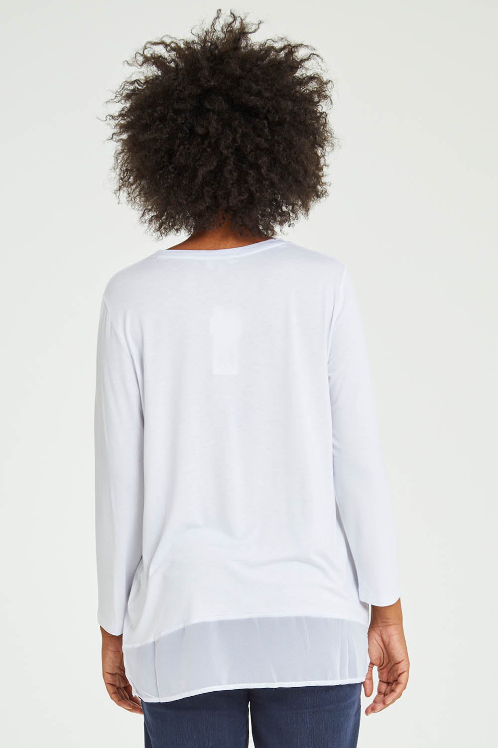 Model Olivia wearing size S of the L/S Georgette Hem Top in colour White (White), from the back