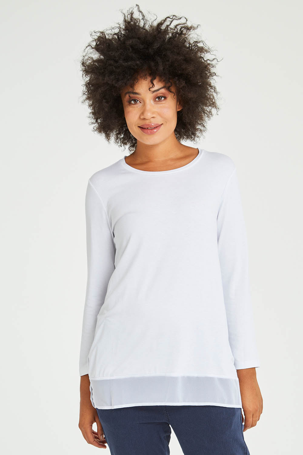 Model Olivia wearing size S of the L/S Georgette Hem Top in colour White (White), from the front, cropped image
