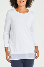 Model Olivia wearing size S of the L/S Georgette Hem Top in colour White (White), from the front, cropped image