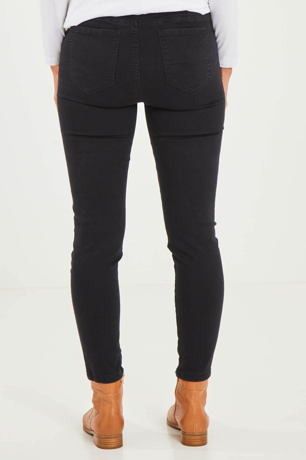 Model Kelly wearing size S of the Pull On Ripped Jeans in colour Black (Black), from the back