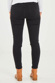 Model Kelly wearing size S of the Pull On Ripped Jeans in colour Black (Black), from the back