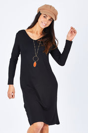 Model Gemma wearing size S of the Reversible Dress in colour Black (Black), from the front, cropped image